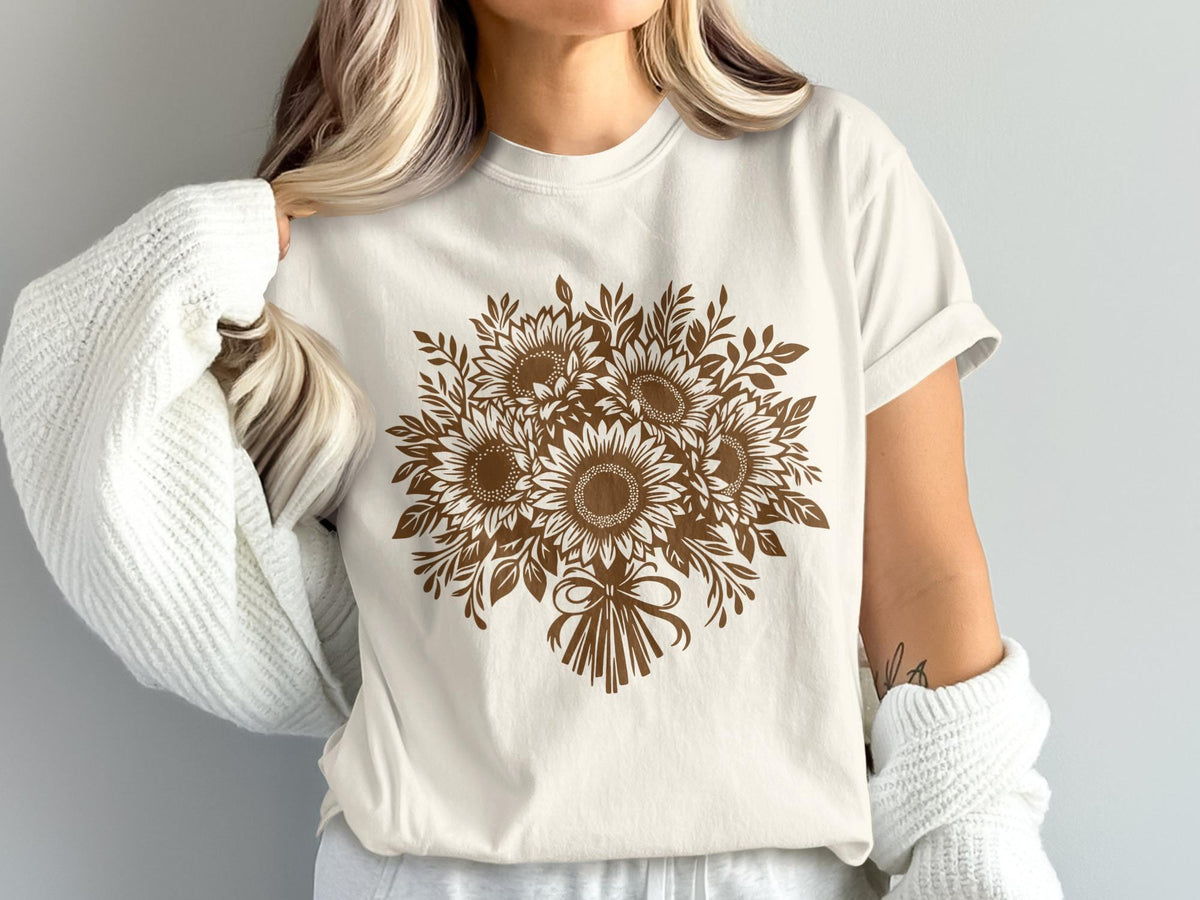 Cream t-shirt with a brown sunflower bouquet graphic and a tied bow.