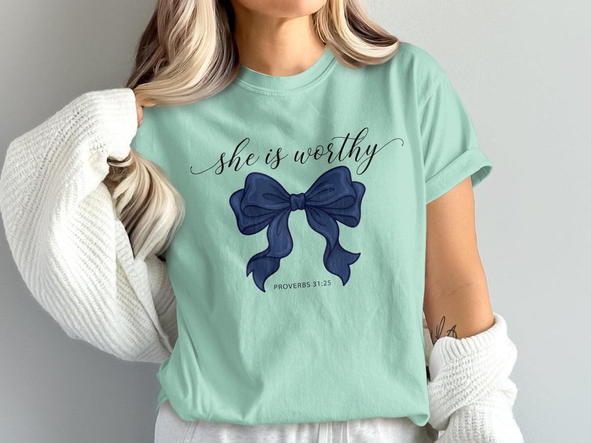 Mint t-shirt with a dark blue bow and "she is worthy" text.