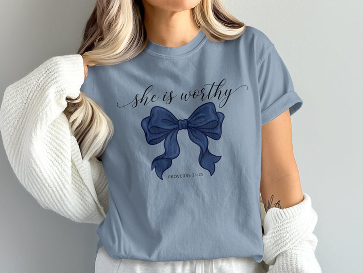 Blue t-shirt with 'she is worthy' text and a dark blue bow graphic.