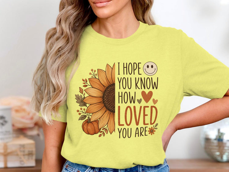 Yellow t-shirt with sunflower, pumpkin, leaves, and "I hope you know how loved you are" text.
