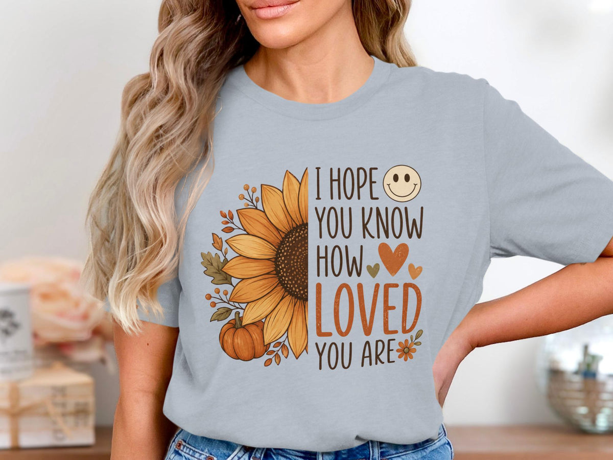 Gray t-shirt with a sunflower, pumpkin, leaves, and the text "I HOPE YOU KNOW HOW LOVED YOU ARE".