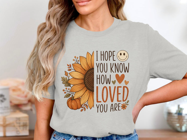 Light grey t-shirt with "I hope you know how loved you are" text and sunflower design.