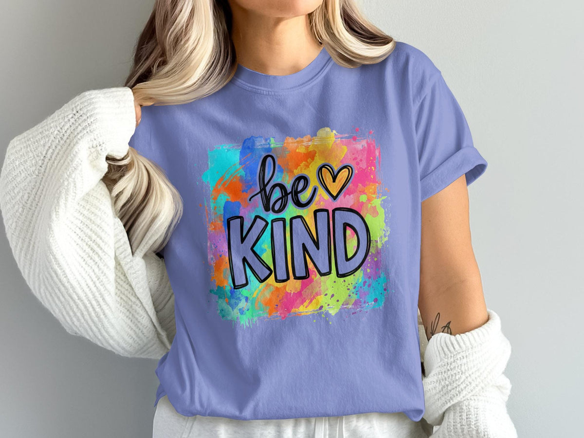 Purple t-shirt with colorful watercolor design and "be KIND" text.