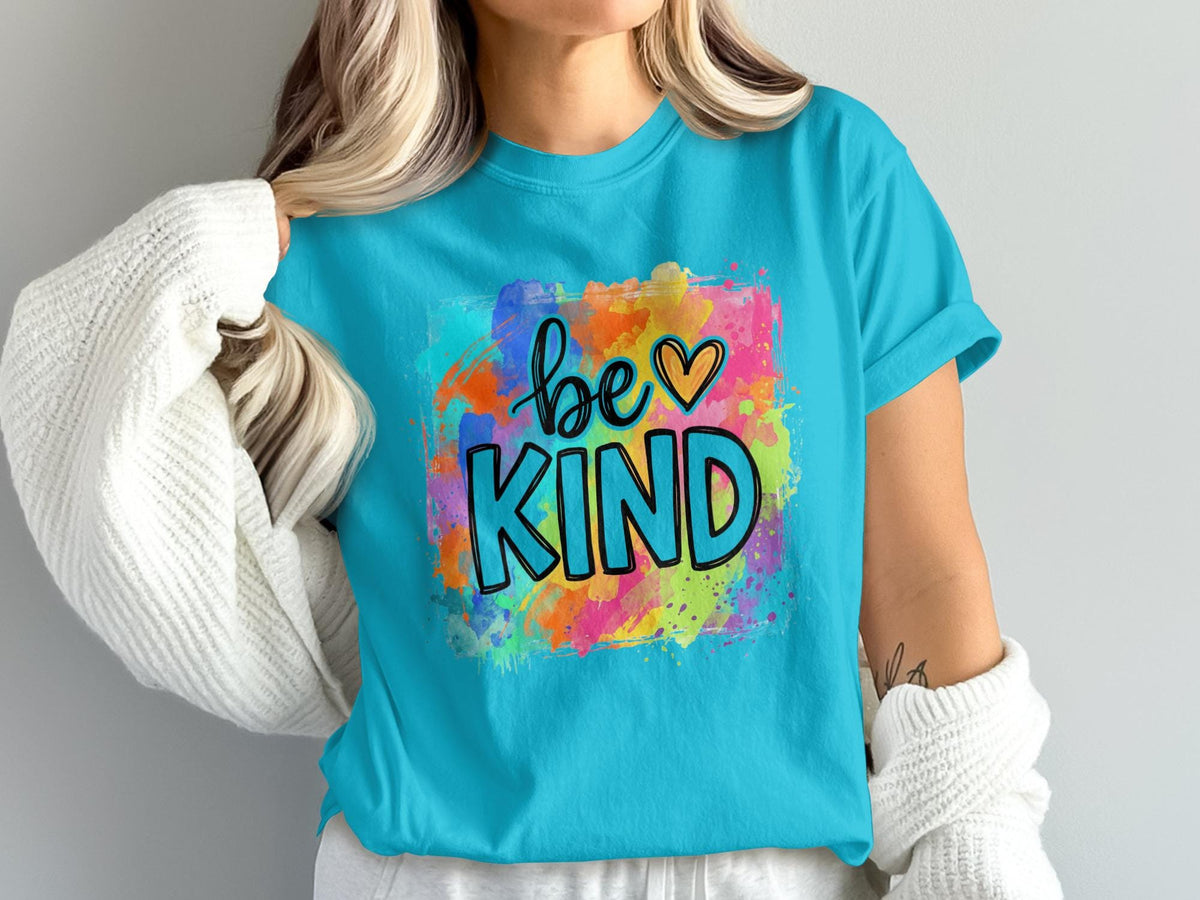 Turquoise t-shirt with "be KIND" text and colorful watercolor background.
