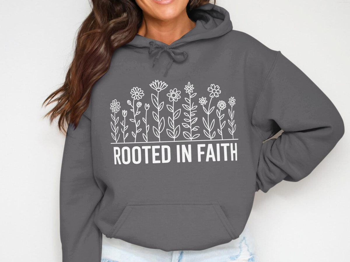 Dark gray hoodie with white floral design and "ROOTED IN FAITH" text.