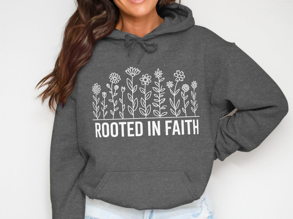 Dark gray hoodie with white floral design and "ROOTED IN FAITH" text.