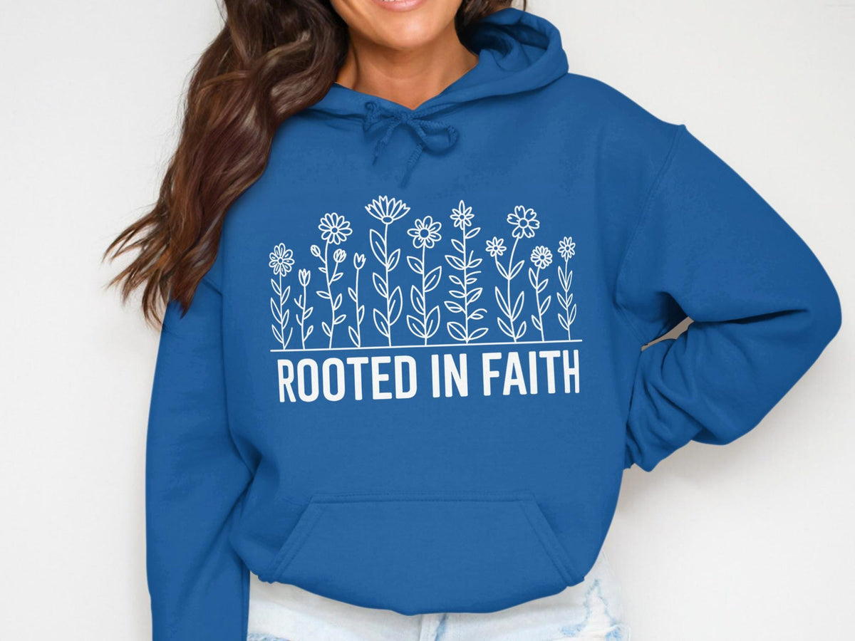 Blue hoodie with white floral design and the text "ROOTED IN FAITH".