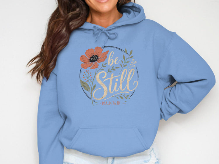 Light blue hoodie with floral design and "be Still Psalm 46:10" text.