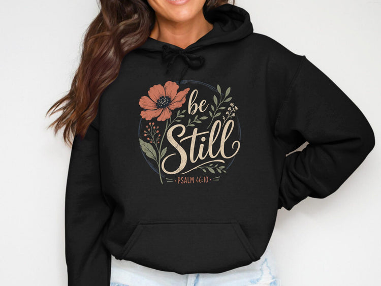 Black hoodie with floral graphic and text "be Still, Psalm 46:10".