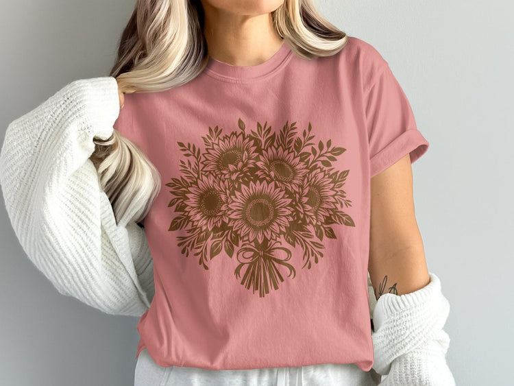 Pink t-shirt with a brown sunflower bouquet graphic and bow detail.