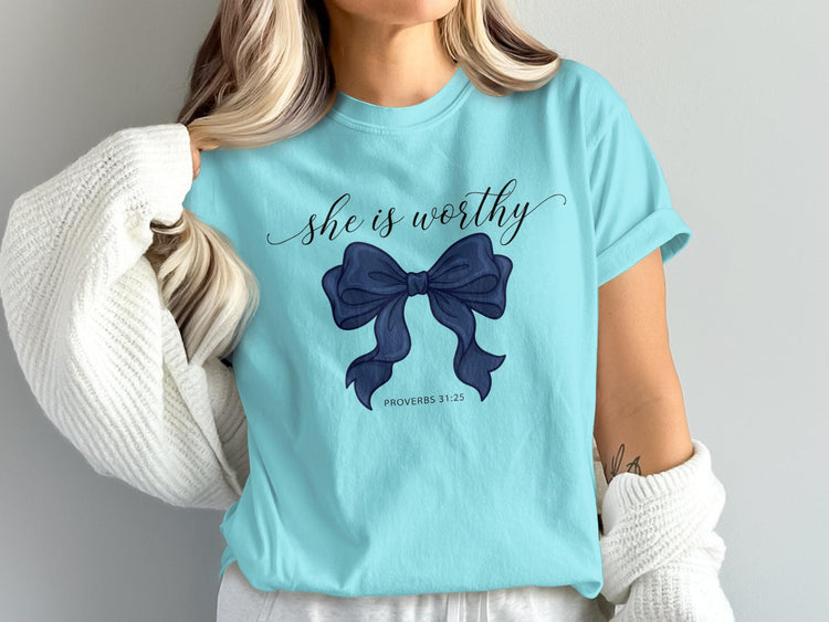 Aqua t-shirt with "she is worthy" and a navy bow, Proverbs 31:25.