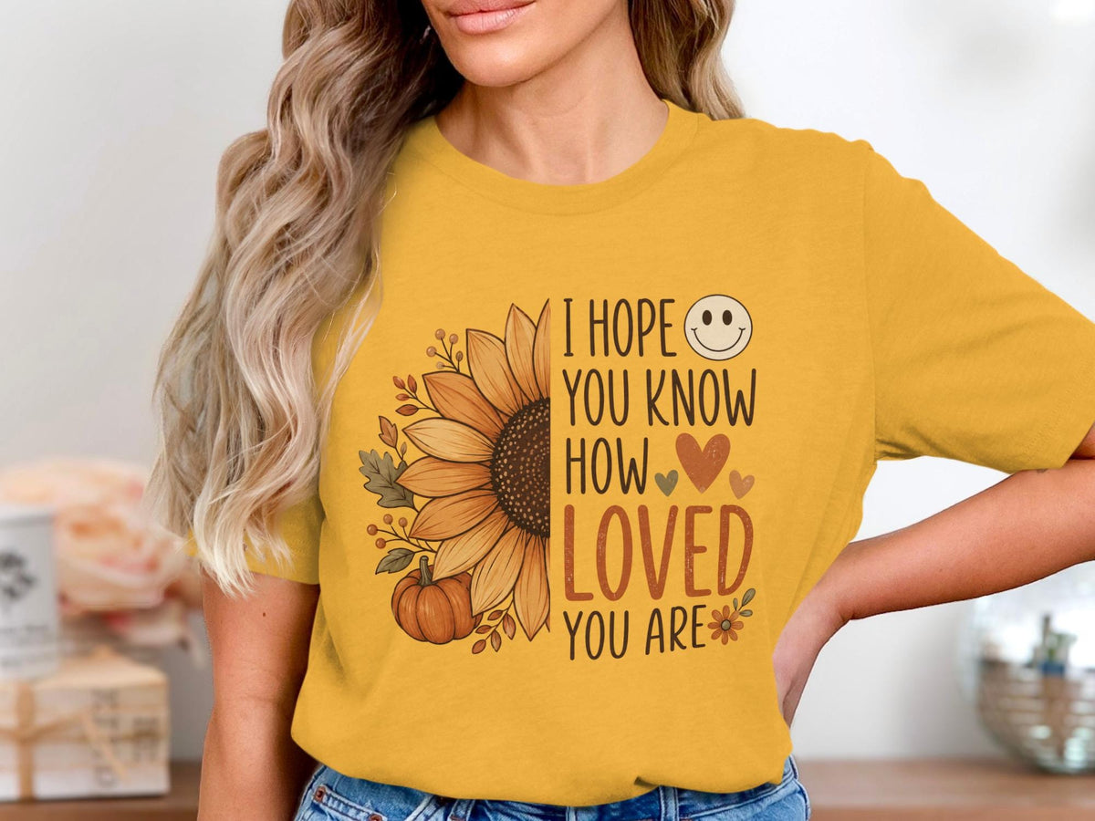 Yellow t-shirt with text "I hope you know how loved you are" and a sunflower.