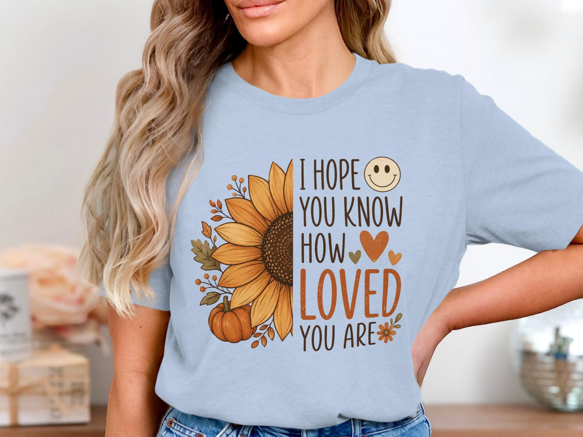 Light blue t-shirt with sunflower, pumpkin, and text "I hope you know how loved you are".