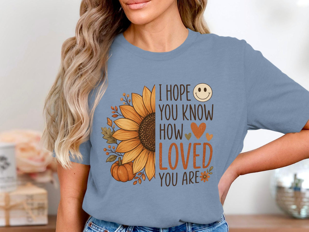 Blue t-shirt with sunflower, pumpkin, leaves, and text: "I hope you know how loved you are."