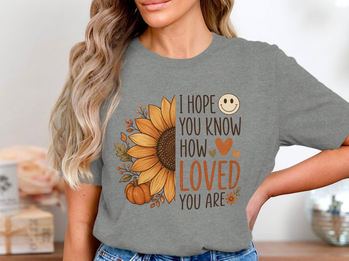 Grey t-shirt with sunflower, pumpkin, and text: I hope you know how loved you are.