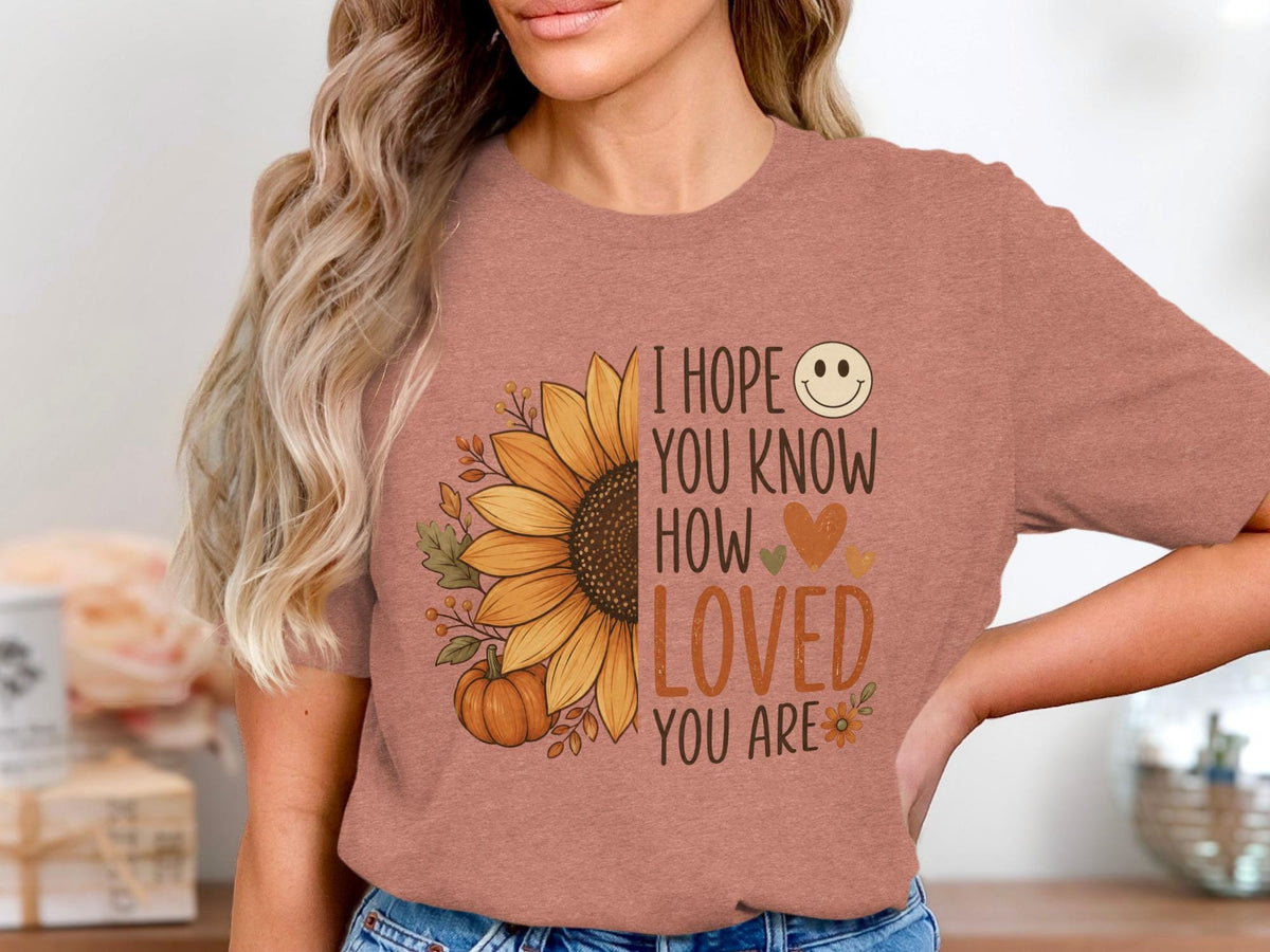T-shirt with sunflower, pumpkin, and "I hope you know how loved you are" text.