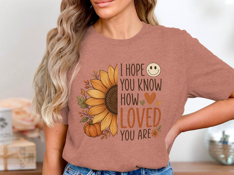 T-shirt with sunflower, pumpkin, and "I hope you know how loved you are" text.