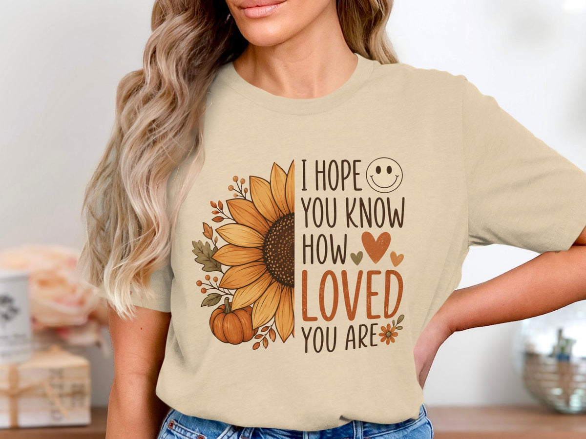 Cream t-shirt with sunflower and text: "I hope you know how loved you are."