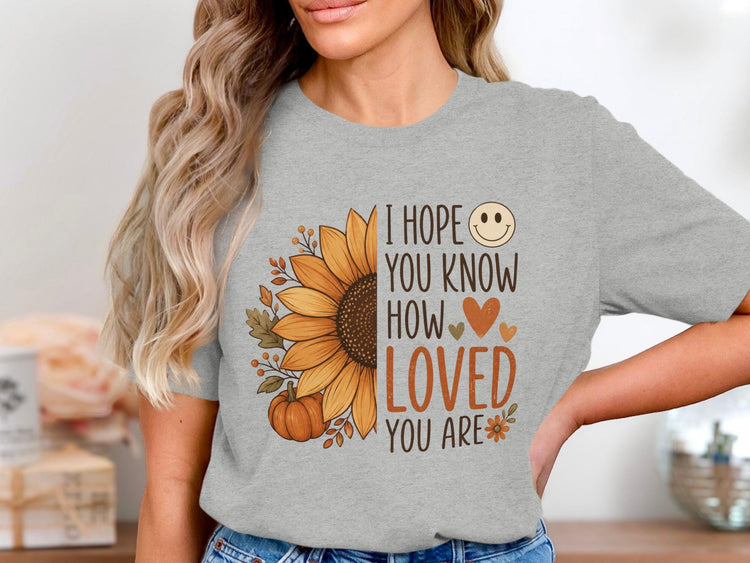 Grey t-shirt with sunflower, pumpkin, and "I hope you know how loved you are" text.