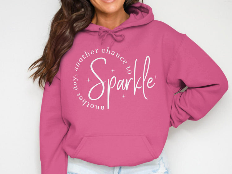 Pink hoodie with white text "another day, another chance to Sparkle".