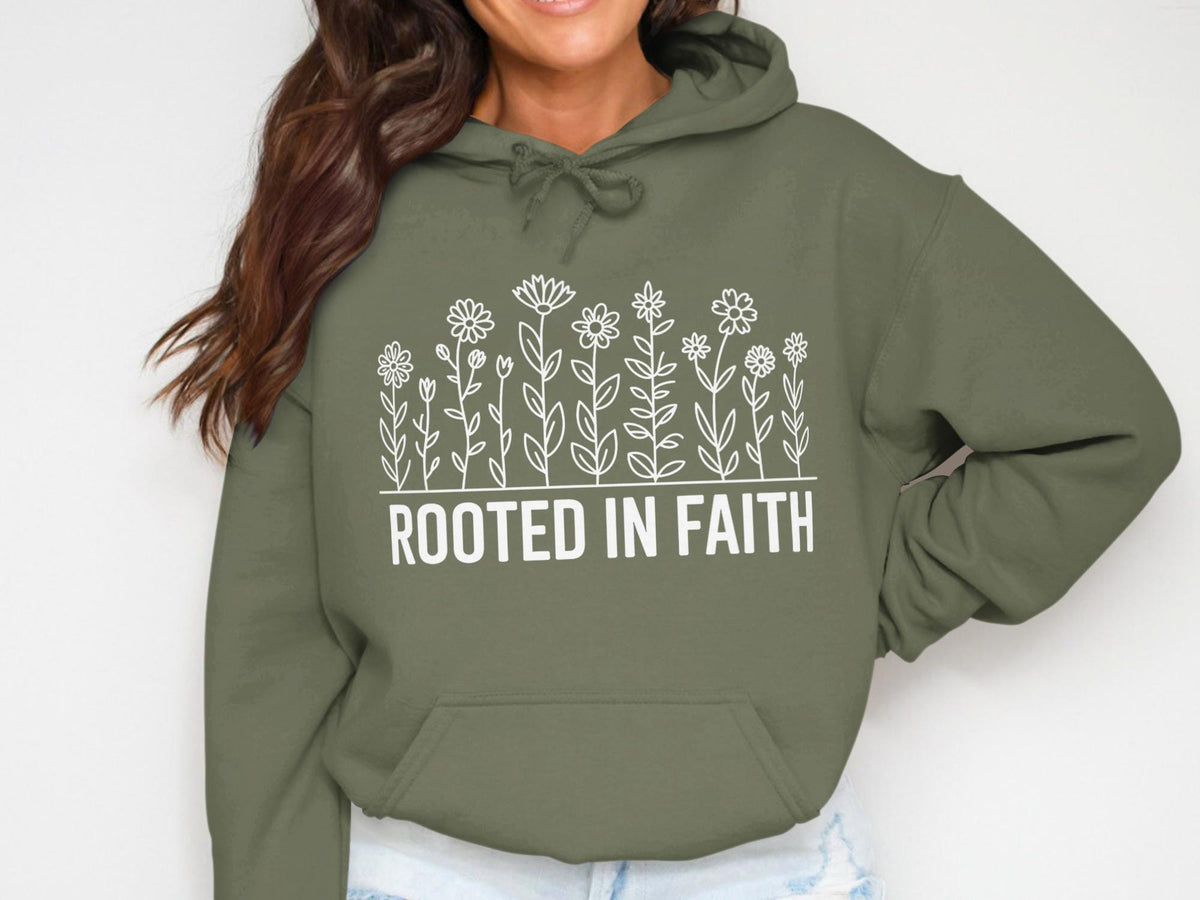 Olive green hoodie with white floral design and "ROOTED IN FAITH" text.