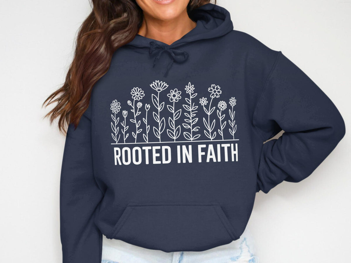 Navy hoodie with white floral design and text "ROOTED IN FAITH".