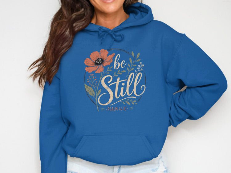 Blue hoodie with "be Still" and floral design, Psalm 46:10.