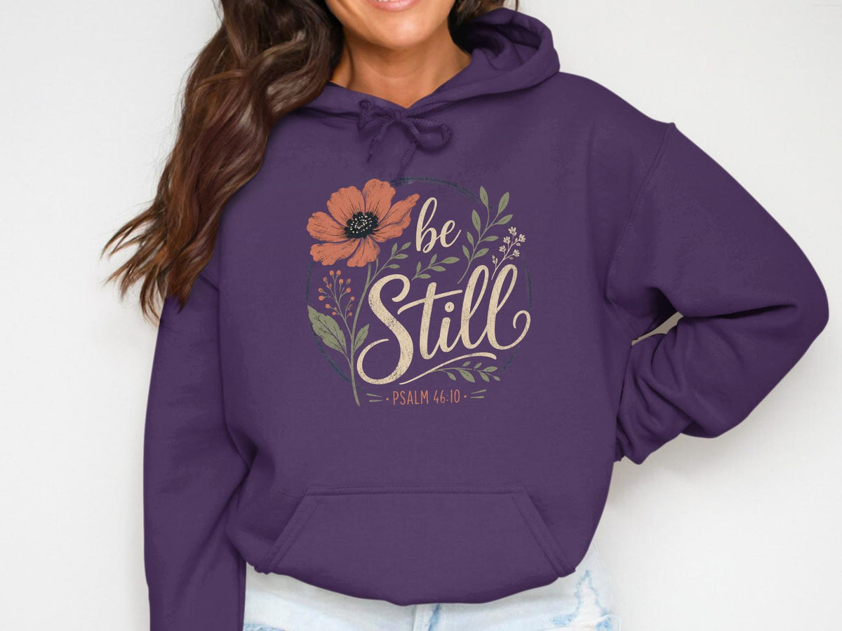 Purple hoodie with floral design and "be Still Psalm 46:10" text.