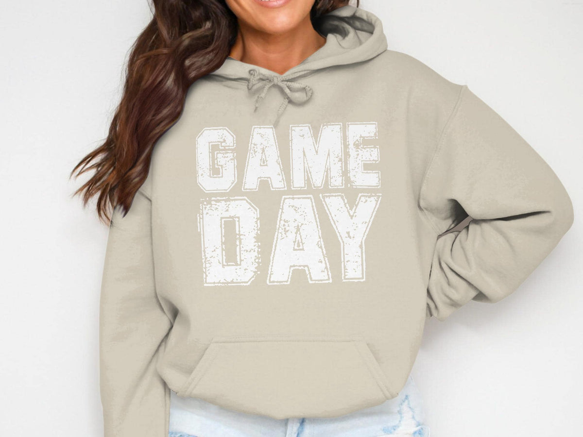Tan hoodie with white "GAME DAY" text in distressed block letters.