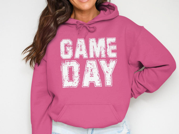 Pink hoodie with white distressed "GAME DAY" graphic and a front pocket.
