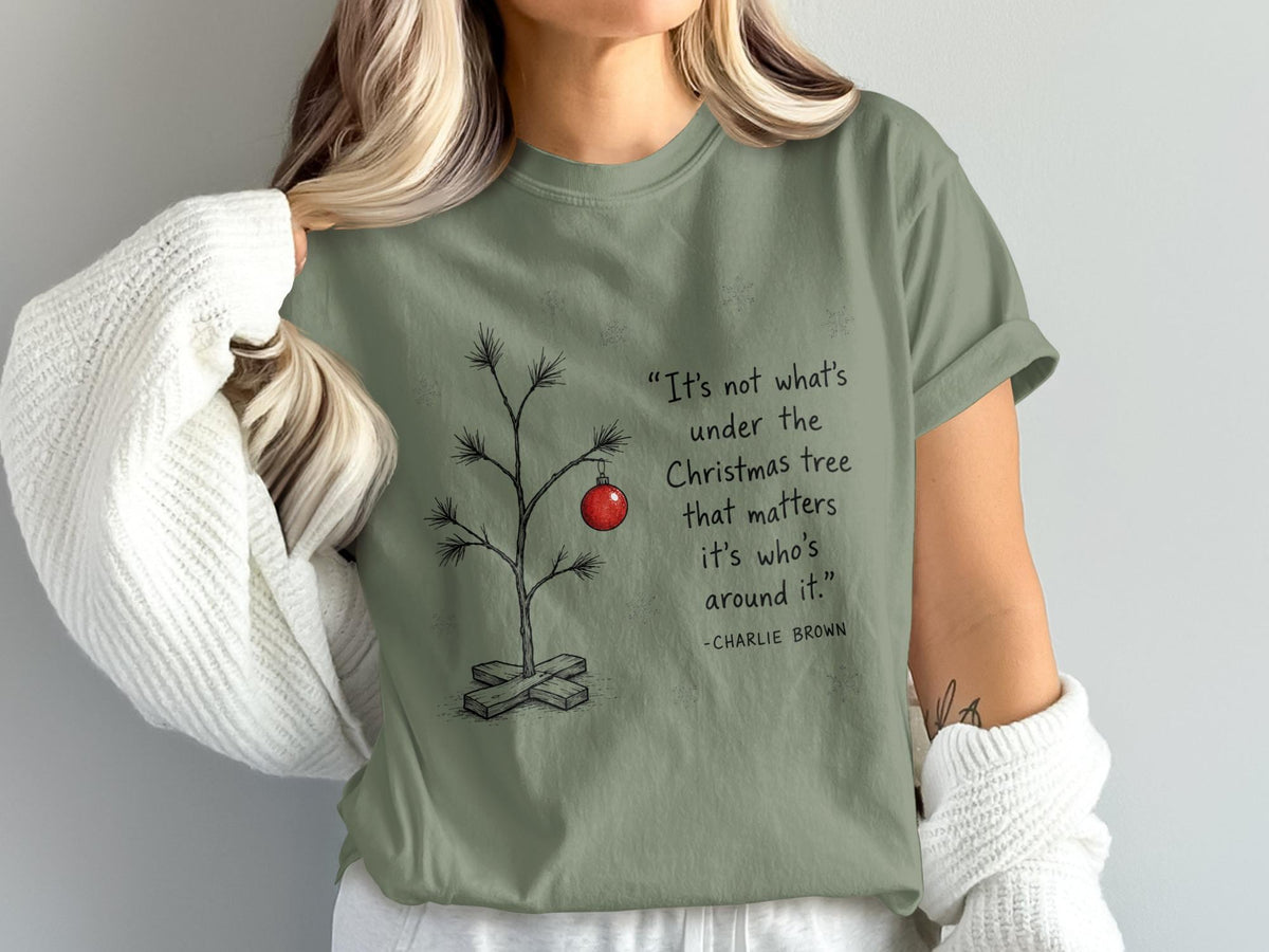Green t-shirt with Charlie Brown quote and a minimalist Christmas tree graphic.