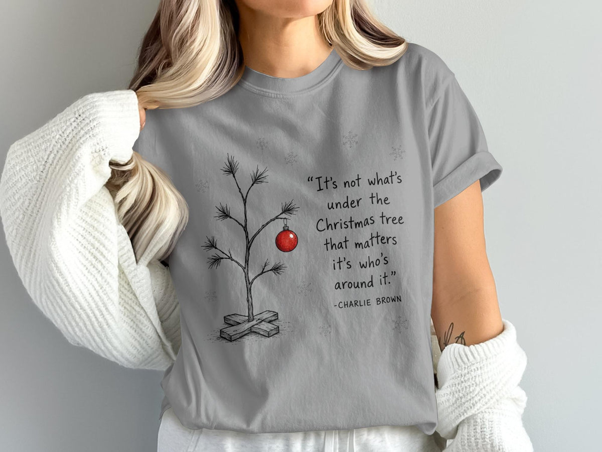 Charlie Brown quote about Christmas trees on a grey t-shirt.