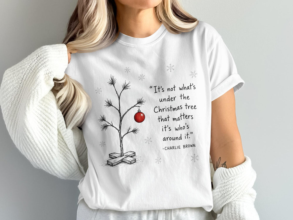 White t-shirt with Charlie Brown quote and minimalist Christmas tree graphic.