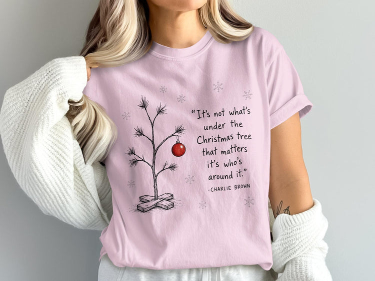 Pink t-shirt with Charlie Brown quote about Christmas tree and loved ones.