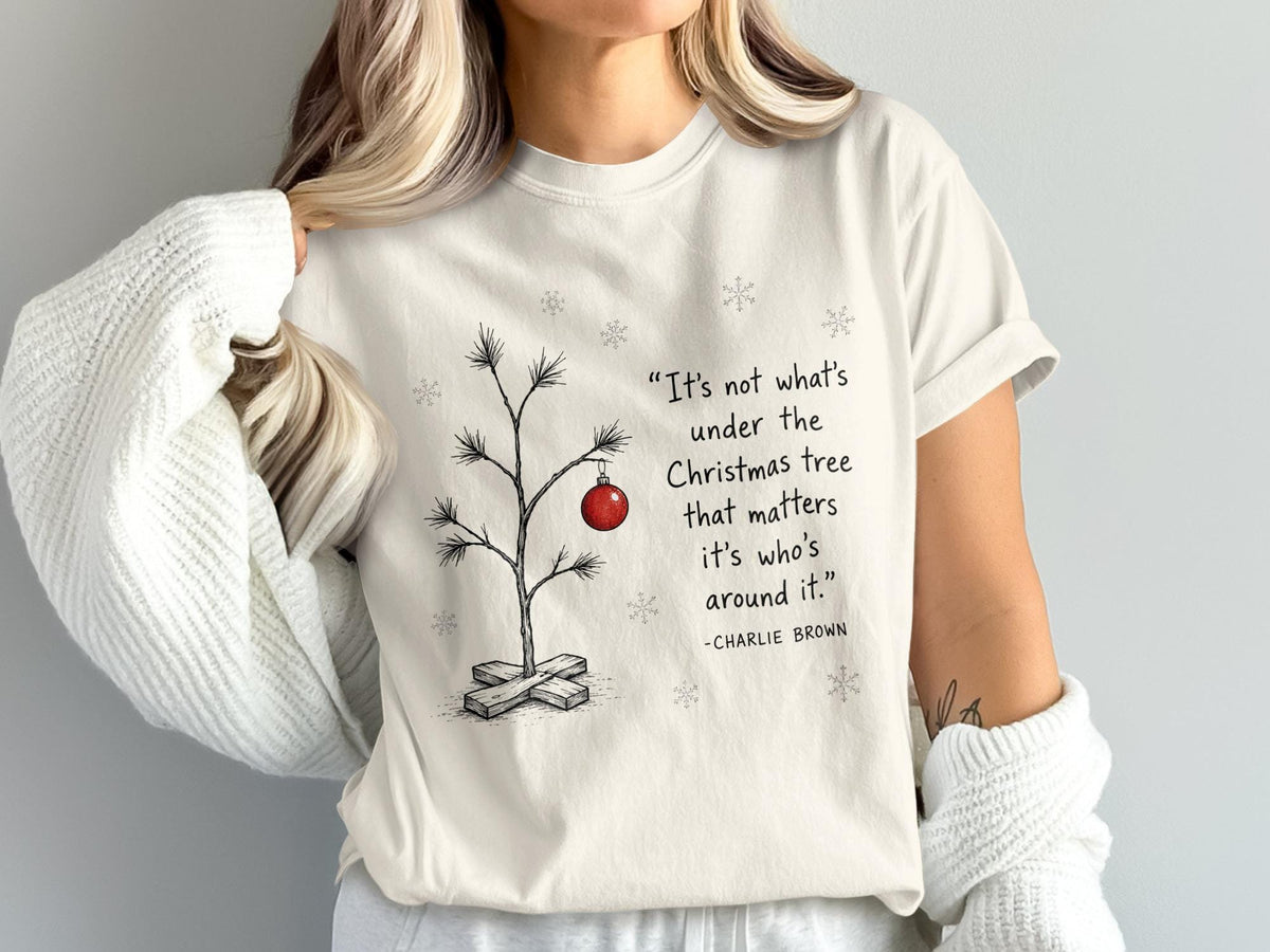 T-shirt with Charlie Brown quote about Christmas and a minimalist tree.