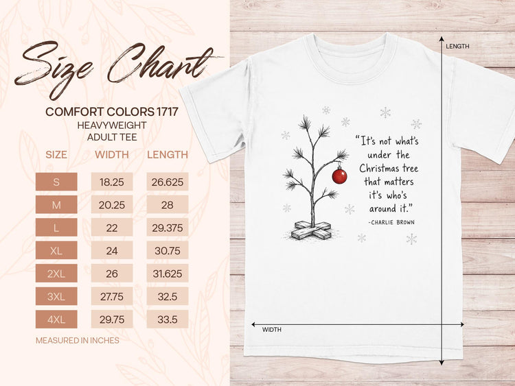 Size chart for heavyweight adult tee with Charlie Brown quote and minimalist Christmas tree graphic.