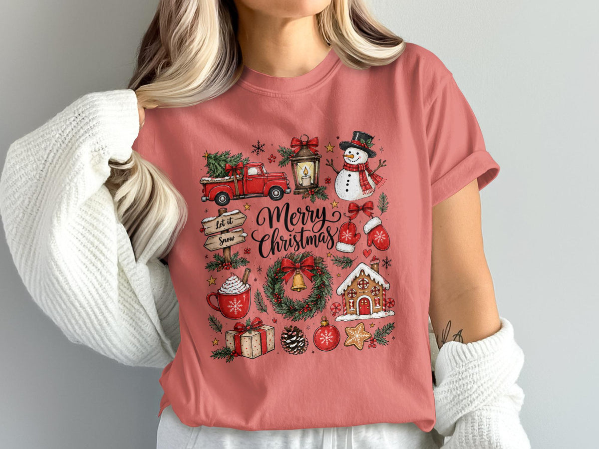 Pink t-shirt with "Merry Christmas" text surrounded by festive winter icons.