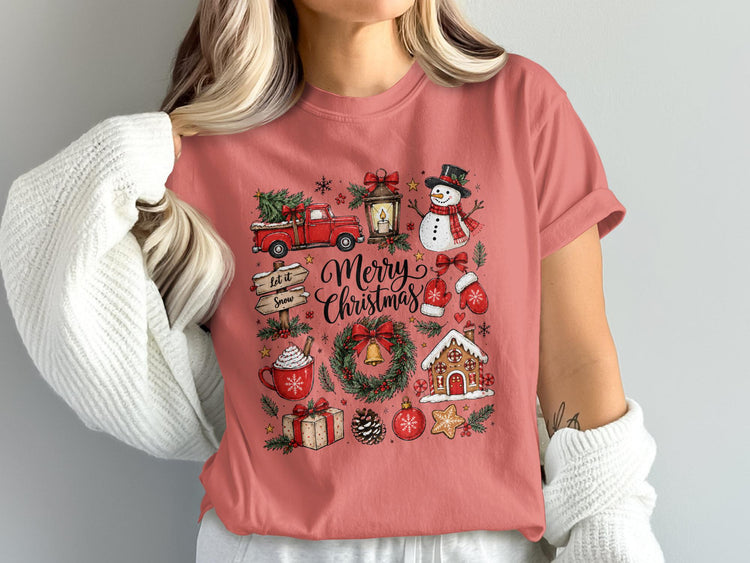 Pink t-shirt with "Merry Christmas" text surrounded by festive winter icons.