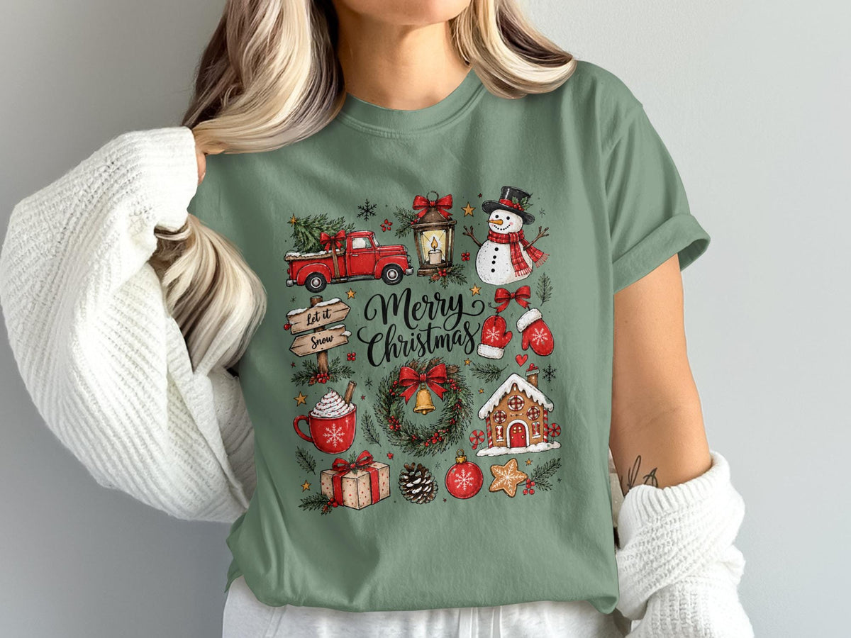 Green t-shirt with Merry Christmas graphic featuring a truck, snowman, gingerbread house, and festive icons.