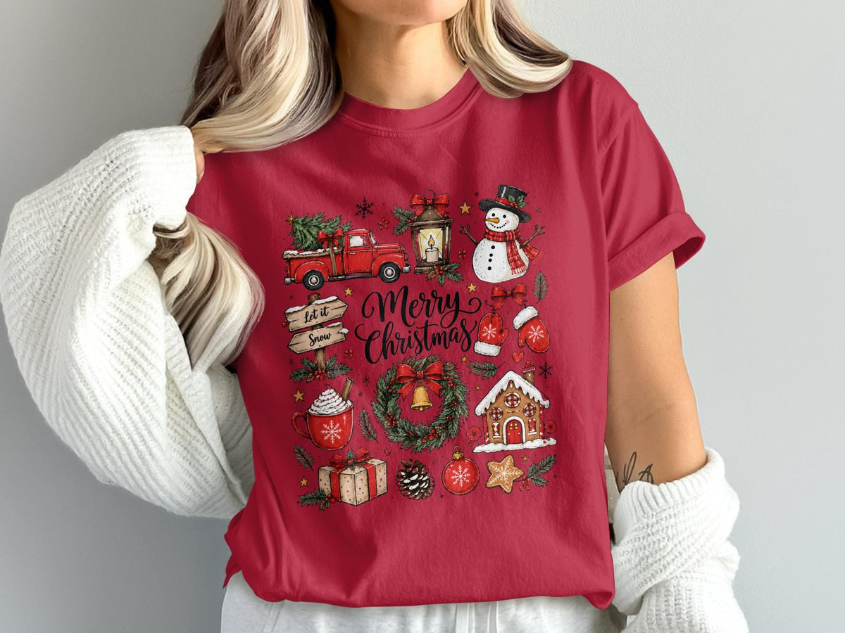 Red t-shirt with Merry Christmas design featuring a truck, snowman, gingerbread house, and hot chocolate.